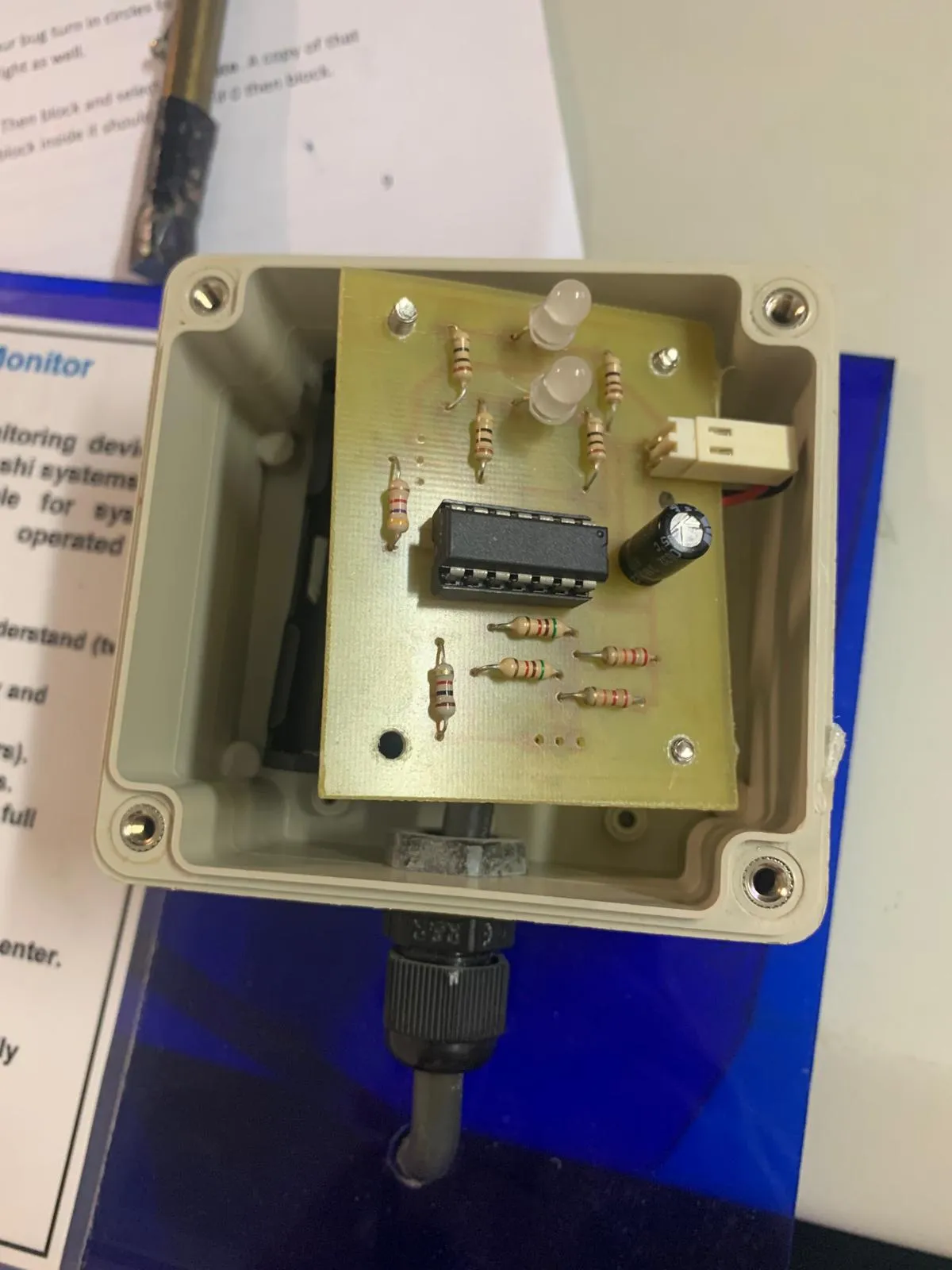 An open Bokashi monitor with a circuit board, LEDs, and electronic components.